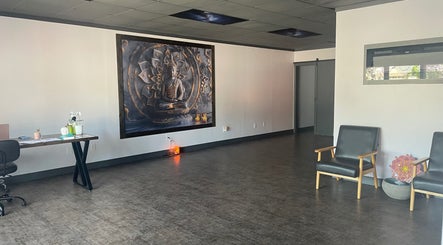 Peaceful seating area with Buddha mural at Salt Spa II, Newport, Tennessee, US. Inviting spiritual ambiance.