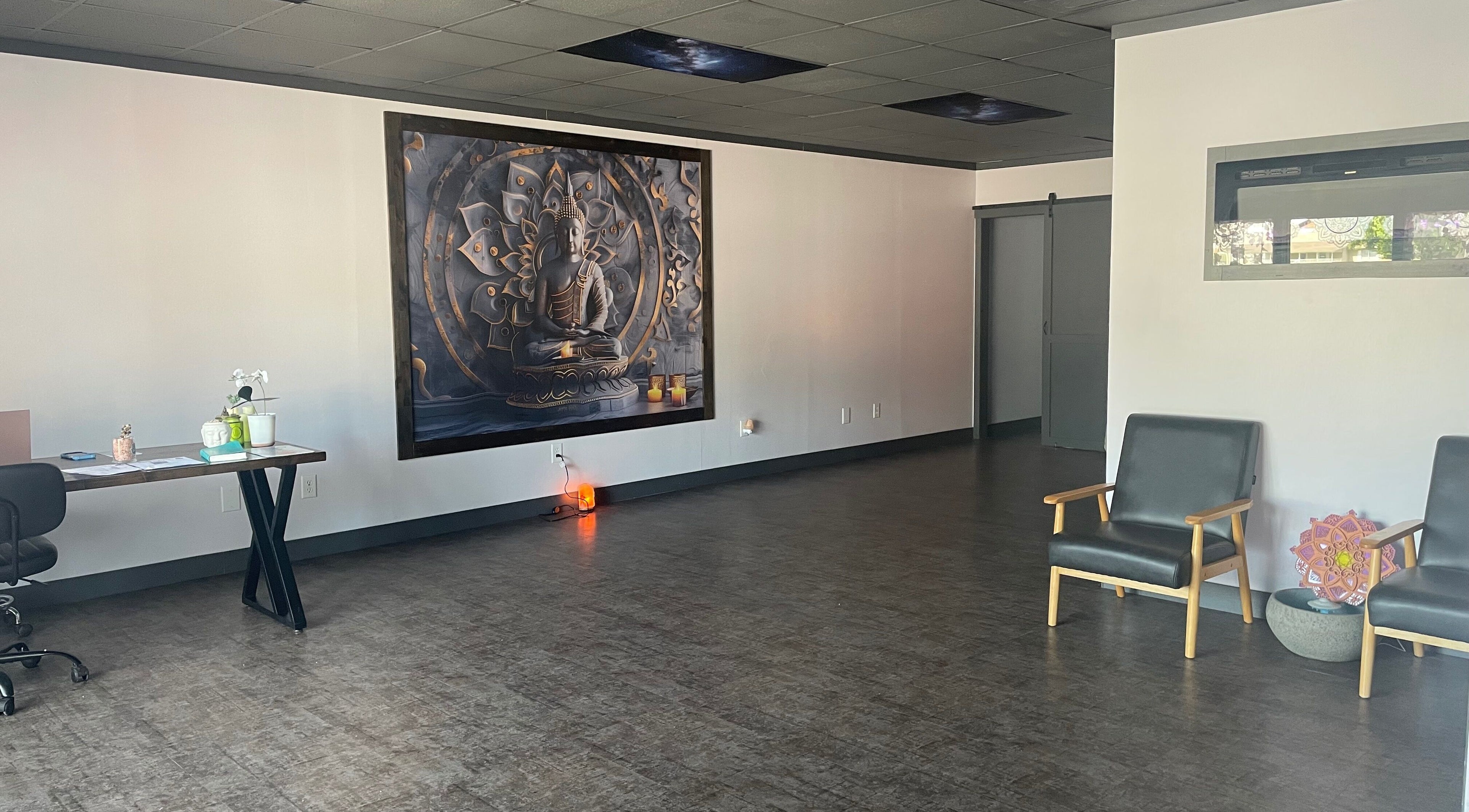 Spacious modern interior of Salt Spa II, Newport, Tennessee, US with serene Buddha painting, desk, and chairs.