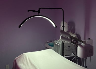 Tranquil treatment room at bn.esthetics, El Paso, Texas, US with spa bed under soothing lighting.