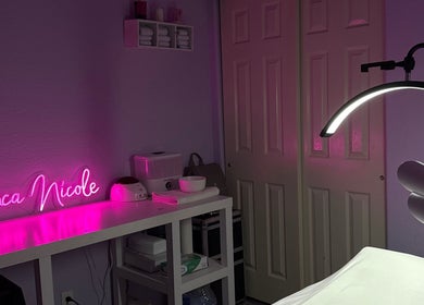 Cozy treatment room with pink neon sign at bn.esthetics in El Paso, Texas, US, featuring modern wellness equipment.