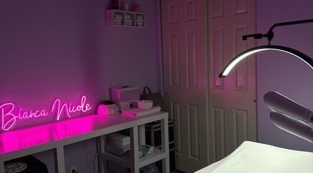 Cozy treatment room with pink neon sign at bn.esthetics in El Paso, Texas, US, featuring modern wellness equipment.