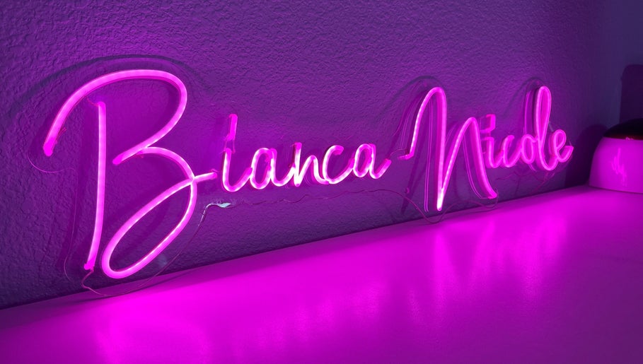 Pink neon sign at Bn.Esthetics in El Paso, Texas, US illuminates the beauty venue ambiance.