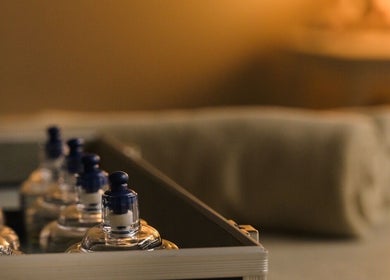 Glass bottles and towel at Essence Body & Soul Massage in Te Puke, Bay Of Plenty Region, NZ, creating a serene vibe.