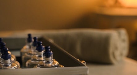 Glass bottles and towel at Essence Body & Soul Massage in Te Puke, Bay Of Plenty Region, NZ, creating a serene vibe.