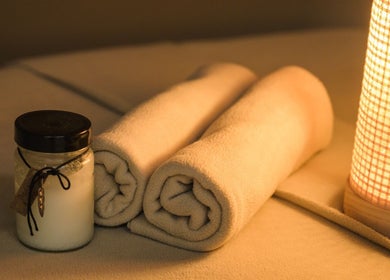 Relaxing ambiance at Essence Body & Soul Massage in Te Puke, Bay Of Plenty Region, NZ with candle and towels.