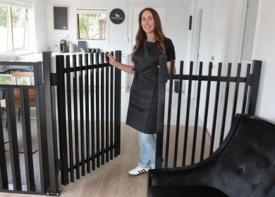 Staff at Barkford Lounge in Auckland, NZ welcomes visitors with a warm smile in a modern, cozy interior setting.