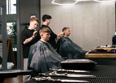 Stylists at Gents & Rascals Barbershop - Britomart Store in Auckland, NZ, expertly cutting hair.