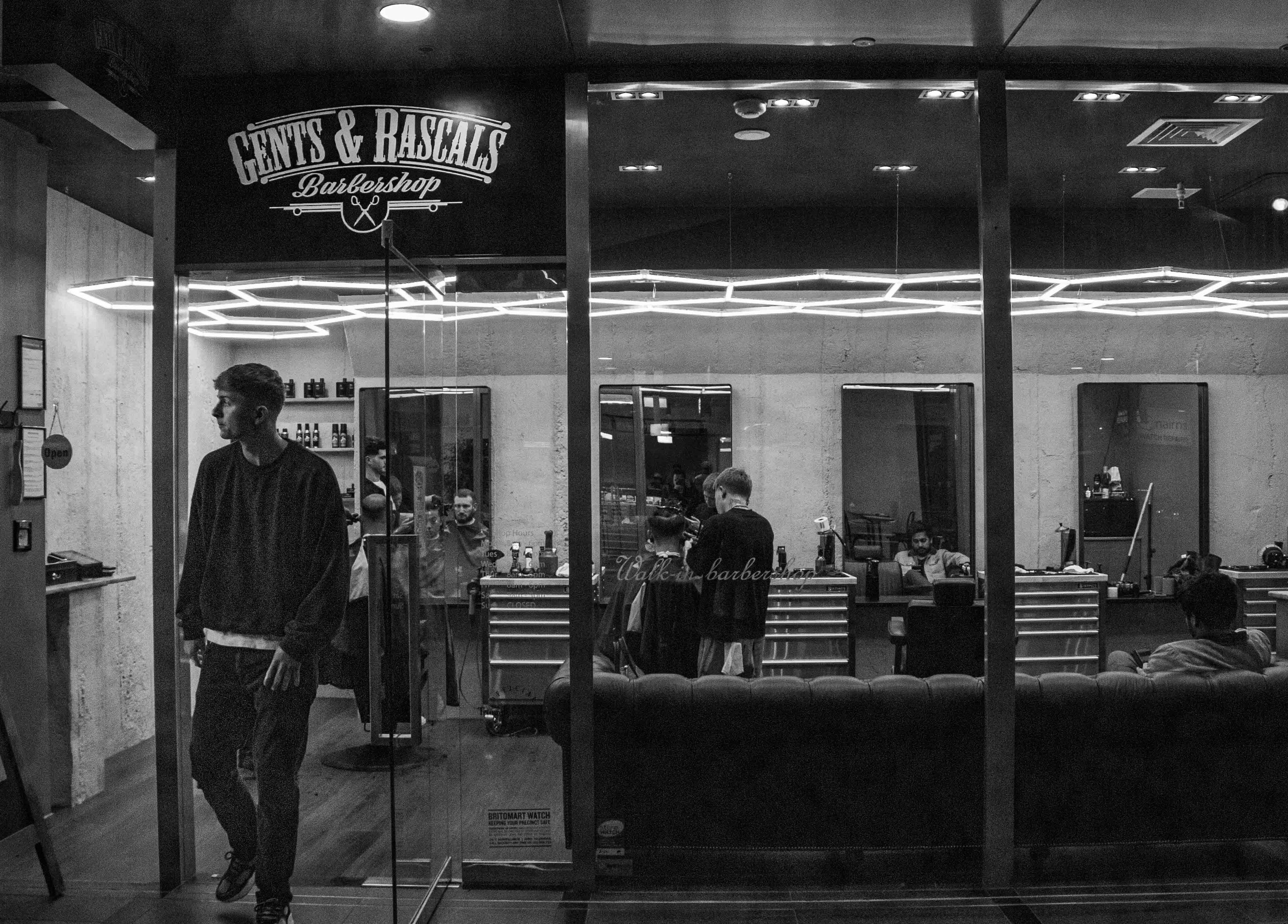 Gents & Rascals Barbershop - Britomart Store, Auckland, NZ. Interior with customers and modern design.