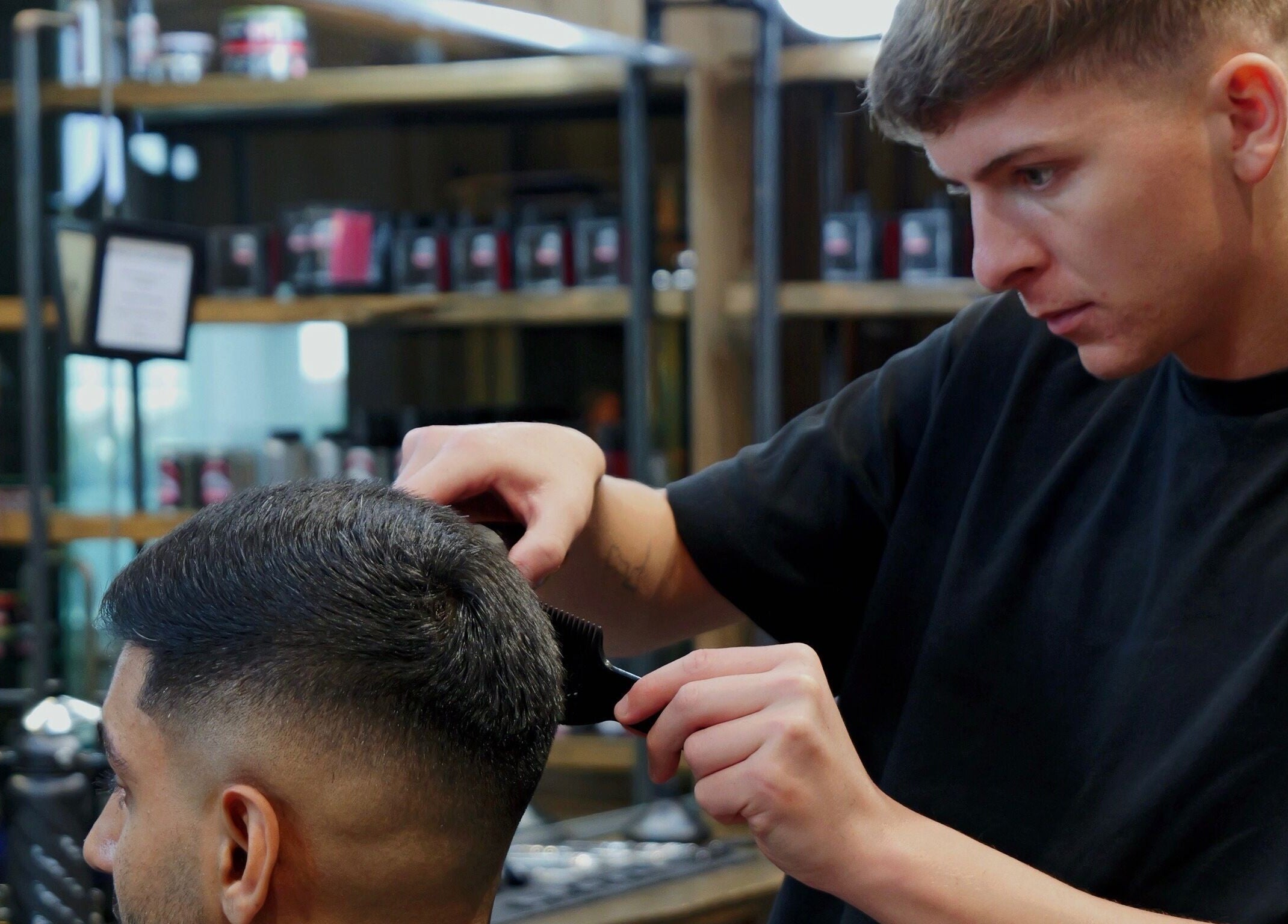 Stylist perfecting haircut at Gents & Rascals barbershop, HSBC tower, Auckland, Auckland, NZ.