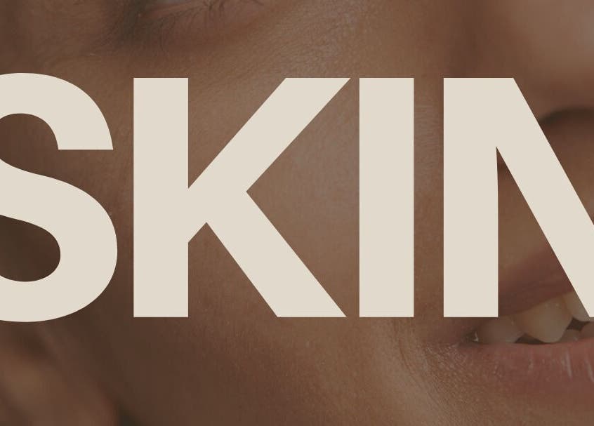 Close-up of a smiling face with the word 'SKIN' at Laser and Skin District, Windsor, New South Wales, AU.