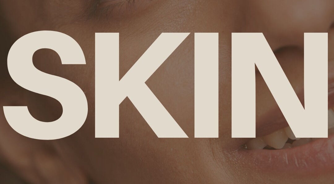 Close-up of a smiling face with the word 'SKIN' at Laser and Skin District, Windsor, New South Wales, AU.