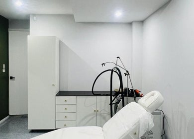 Treatment room at Summer Cosmetics Studio, Catherine Field, New South Wales, AU, with a plush white bed.