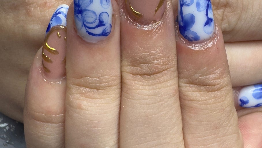 Elegant blue and gold hand-painted nails at WyldNails, Bilsthorpe, England, GB.