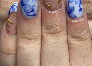 Elegant blue and gold hand-painted nails at WyldNails, Bilsthorpe, England, GB.