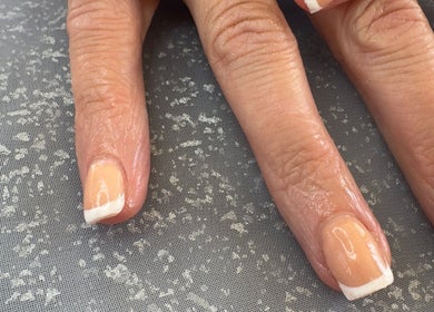 Elegant French manicure at WyldNails, Bilsthorpe, England, GB, showcasing glossy, well-groomed nails.