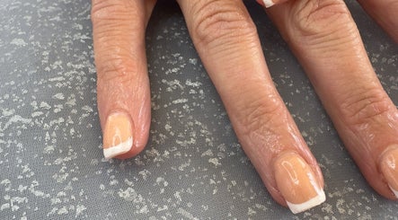 Elegant French manicure at WyldNails, Bilsthorpe, England, GB, showcasing glossy, well-groomed nails.