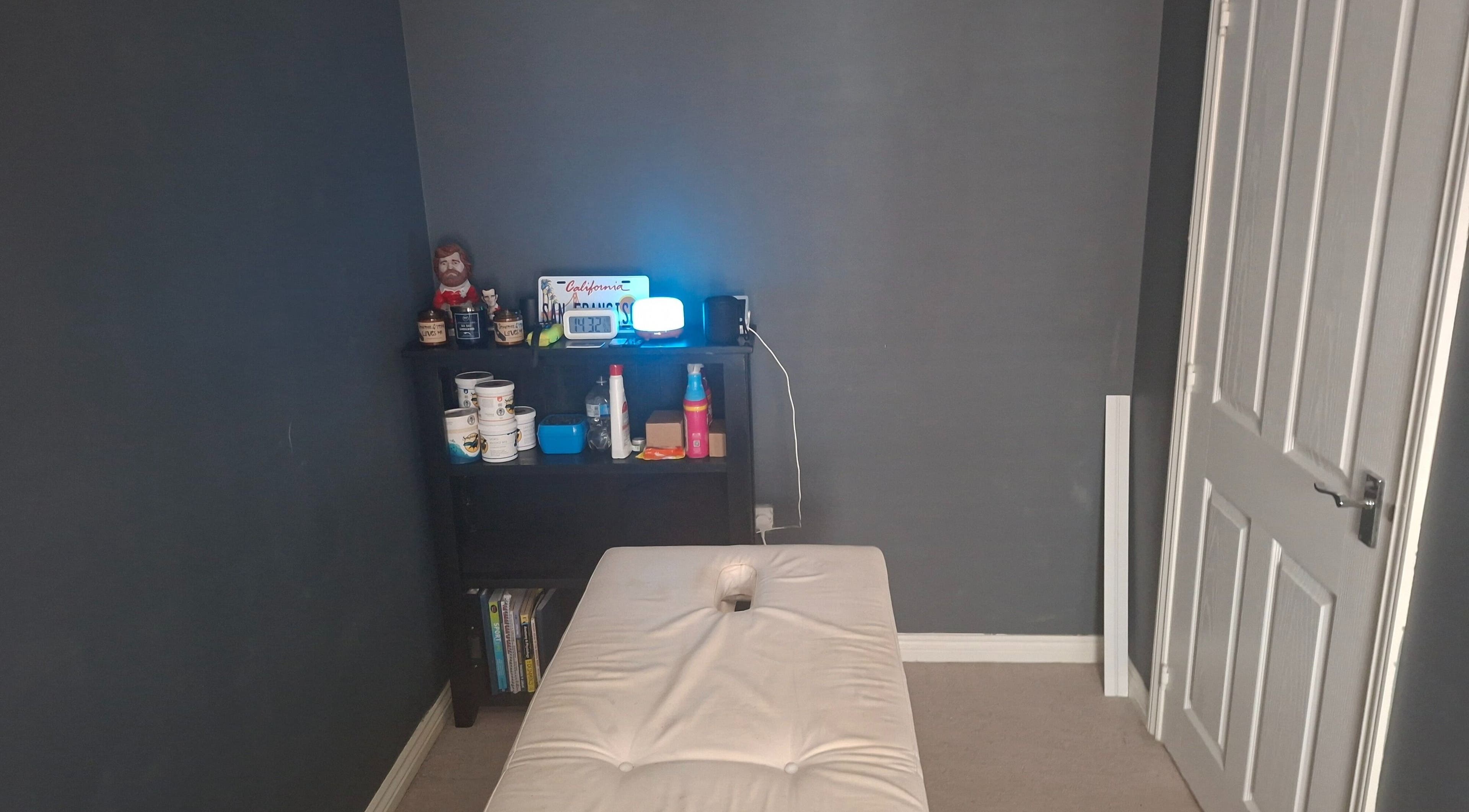 Cozy massage room at REJuvenate, Llanelli, Wales, GB with massage bed and relaxation essentials.