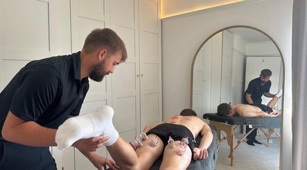 A therapist performing cupping therapy at SGM Sports Therapy Ltd, East Morton, England, GB.