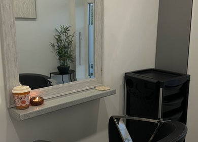 Cozy salon corner at Hair By Rubes, Swinton, England, GB, featuring a stylish mirror and plant decor.