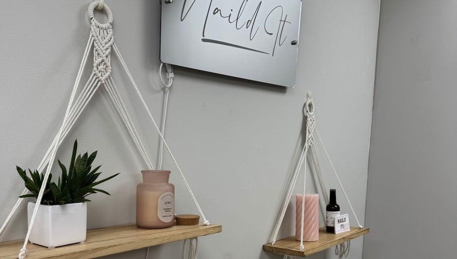 Elegant wall display at Nail’d it!, Yeovil, England, GB featuring hanging shelves and decorative items.