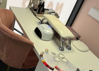 Nail’d it! cozy nail station in Yeovil, England, GB featuring a chair, UV lamp, and nail color palette.