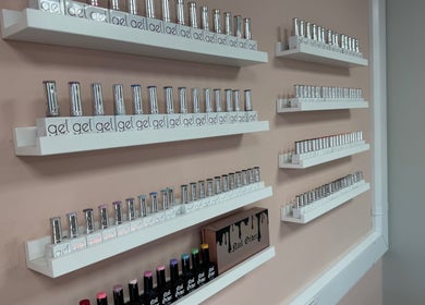 Wall of colorful gel polishes at Nail’d it! in Yeovil, England, GB, showcasing variety for nail artistry.