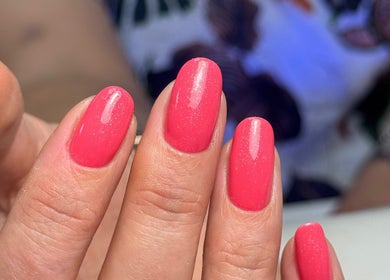 Bright pink manicure at Nail’d it! in Yeovil, England, GB. Perfectly polished nails shine vibrantly.