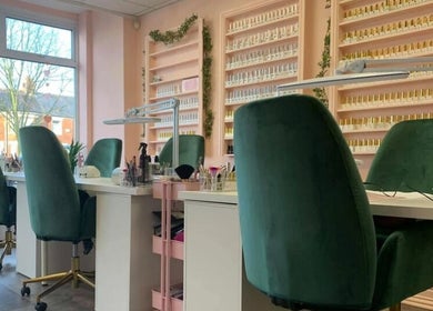 Manicure stations at Charley_thedollshouse in Hessle, England, GB with plush green chairs and polish displays.