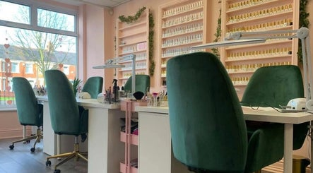 Manicure stations at Charley_thedollshouse in Hessle, England, GB with plush green chairs and polish displays.