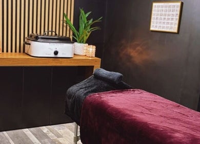 Relaxing massage room at Charley_thedollshouse, Hessle, England, GB, with plush bed and soothing decor.