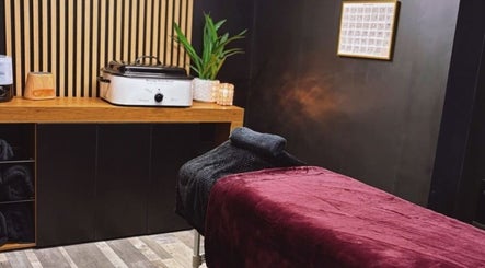 Relaxing massage room at Charley_thedollshouse, Hessle, England, GB, with plush bed and soothing decor.