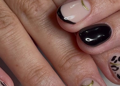 Stylish black and gold nail art at Niche Nails in Ellesmere Port, England, GB.
