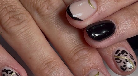 Stylish black and gold nail art at Niche Nails in Ellesmere Port, England, GB.