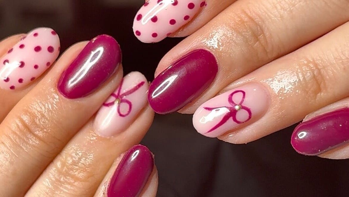 Chic nail art with pink bows at Niche Nails, Ellesmere Port, England, GB.