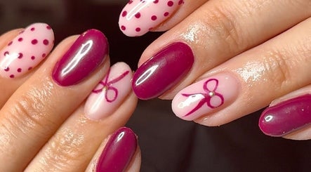 Chic nail art with pink bows at Niche Nails, Ellesmere Port, England, GB.