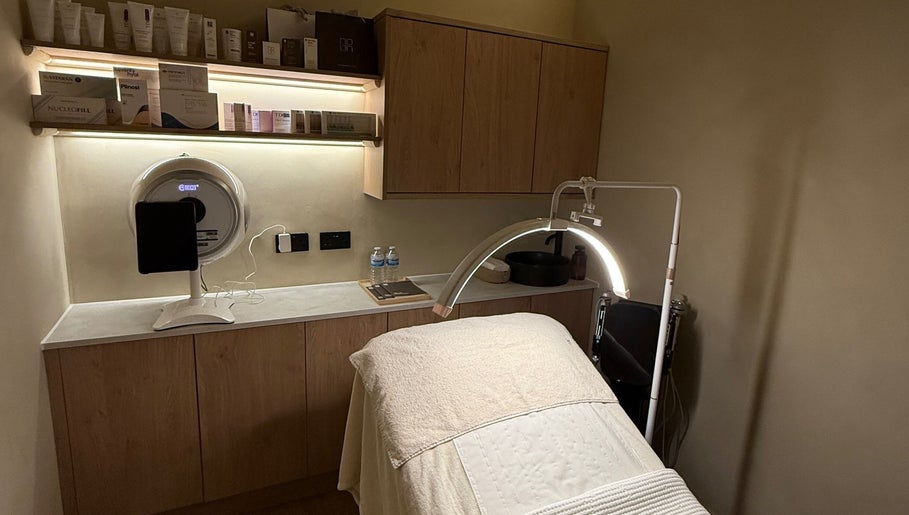 Treatment room at NAUI SKIN Aesthetics at The Ladies Lounge, Weeford, England. Featuring treatment bed and products.