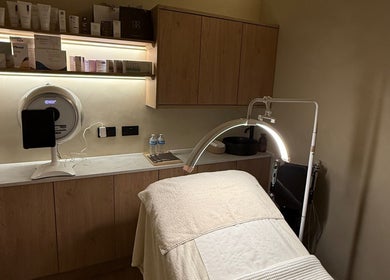 Treatment room at NAUI SKIN Aesthetics at The Ladies Lounge, Weeford, England. Featuring treatment bed and products.