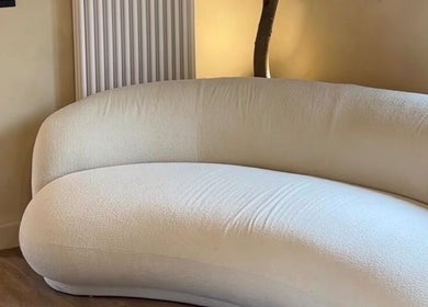 Luxurious curved sofa at NAUI SKIN Aesthetics in The Ladies Lounge, Weeford, England, GB. Perfect for relaxation.