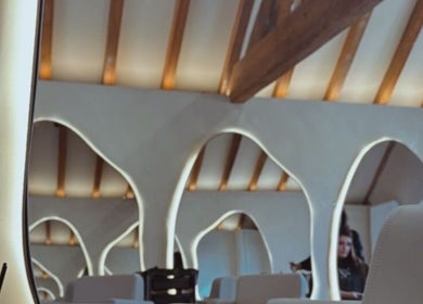 Elegant interior of NAUI SKIN Aesthetics at The Ladies Lounge in Weeford, England, with stylish mirrors and seating.
