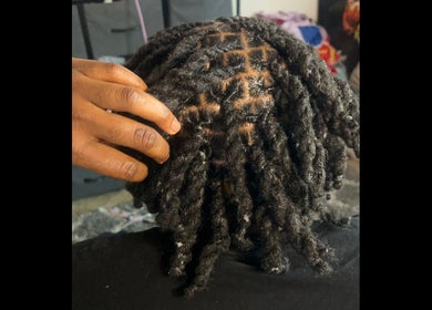 Intricate dreadlock styling at _styledbymarie444 in Hammond, Indiana, US showcasing texture and design.