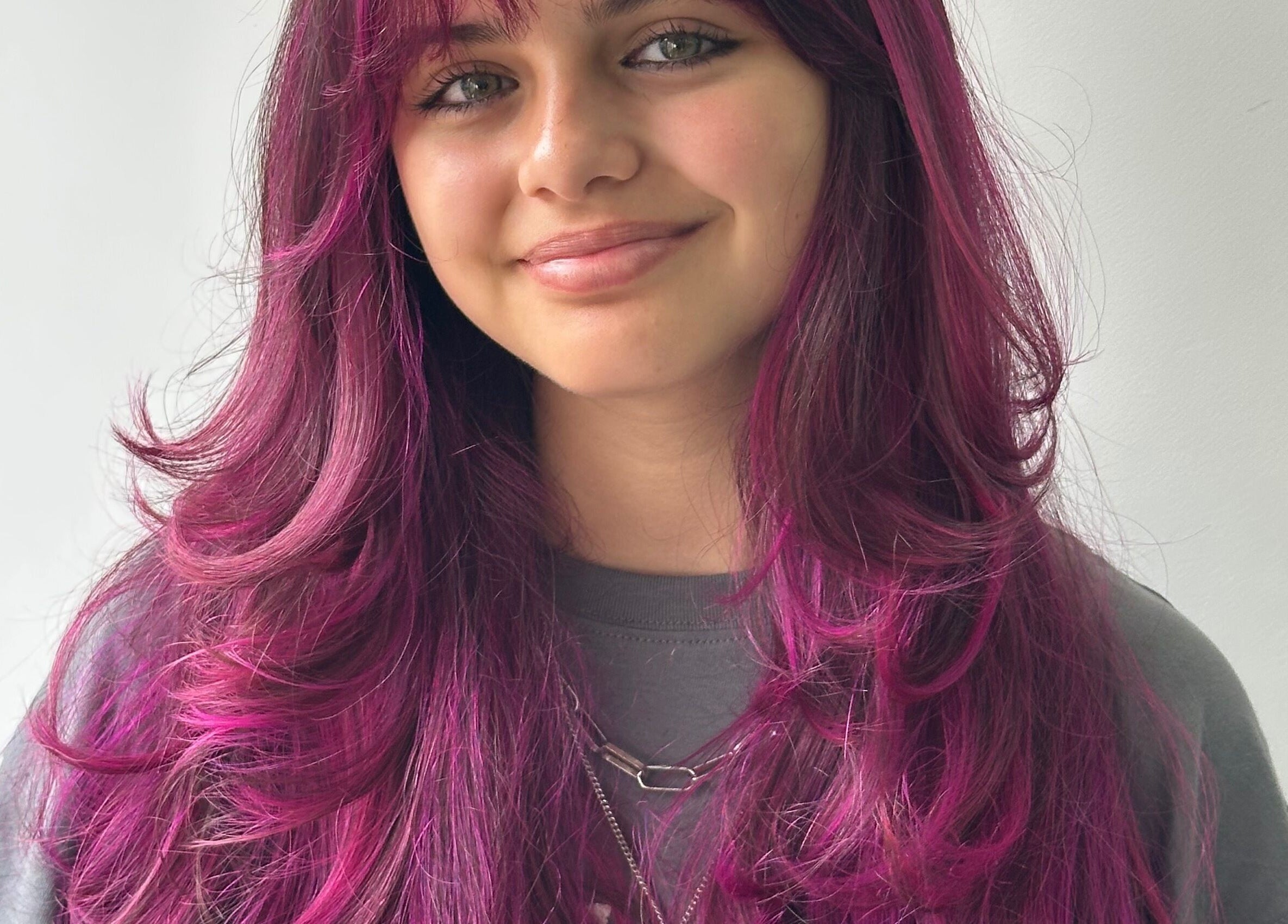 Model with vivid pink hair at Jessi Porphyrio hair, Smethwick, England, GB.
