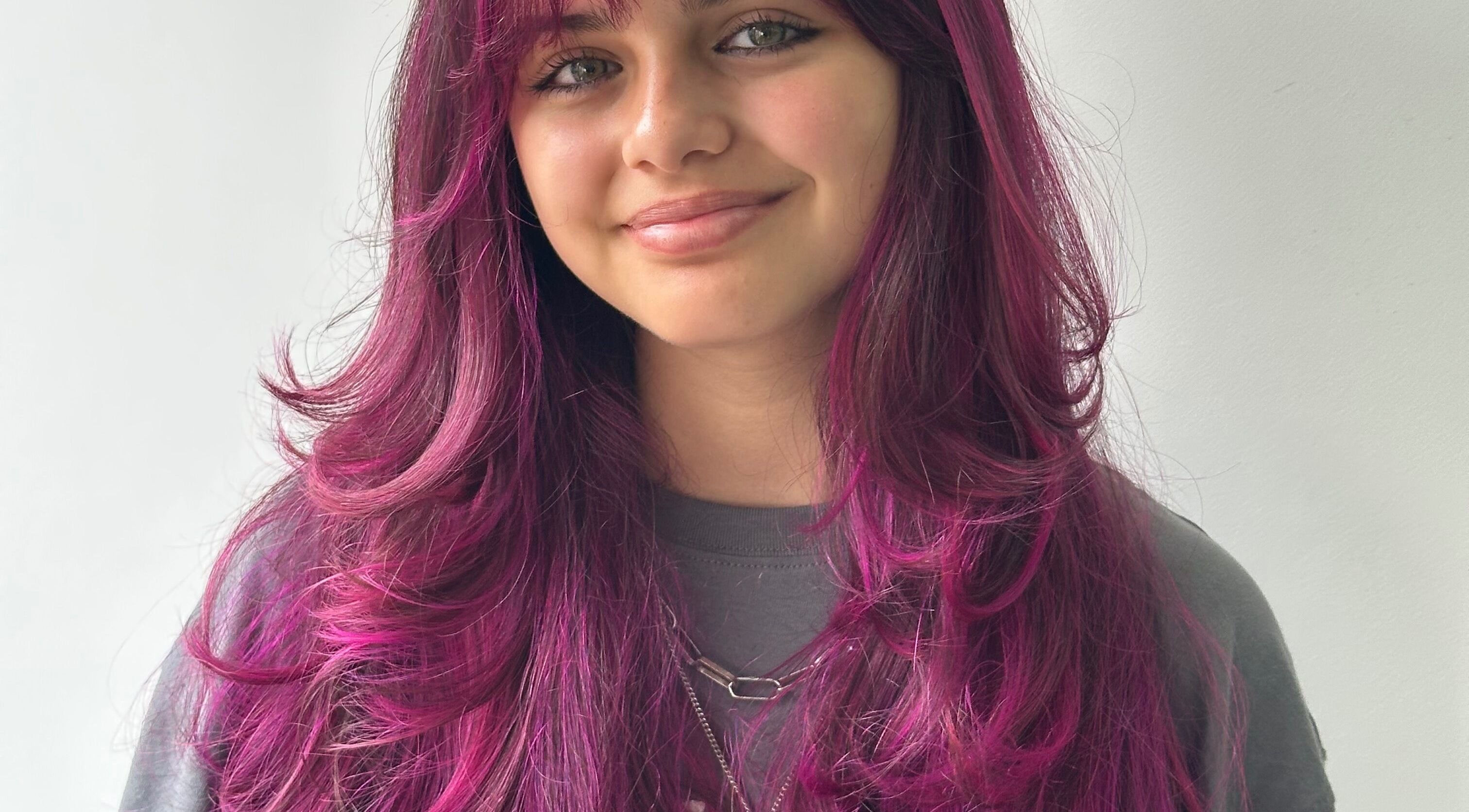 Model with vivid pink hair at Jessi Porphyrio hair, Smethwick, England, GB.