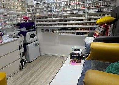 Cozy nail salon Glow in Style Nails in Singapore, SG, showcasing extensive polish collection and comfy chairs.