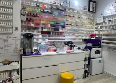 Vibrant nail polish wall at Glow in Style Nails, Singapore, SG, showcasing colorful manicure choices.