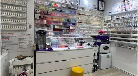 Vibrant nail polish wall at Glow in Style Nails, Singapore, SG, showcasing colorful manicure choices.