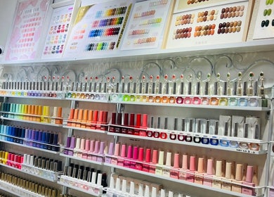 Colorful nail polish display at Glow in Style Nails, Singapore, SG showcasing a vibrant array of options.