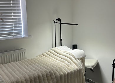 Relaxing treatment room at Defined By Freya, Attleborough, England, GB with cozy bed and soft lighting.