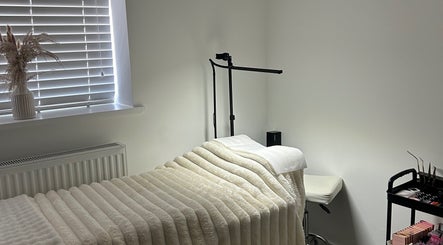 Relaxing treatment room at Defined By Freya, Attleborough, England, GB with cozy bed and soft lighting.