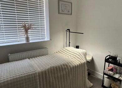 Tranquil therapy room at Defined By Freya, Attleborough, England, GB, showcasing a neatly made treatment bed.