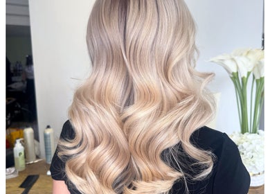Elegant blonde waves styled at Isabelle Grace Hair, Burnley, England, GB.